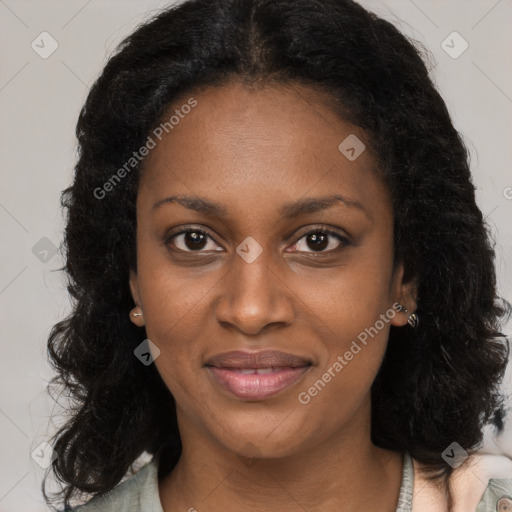 Joyful black young-adult female with long  brown hair and brown eyes