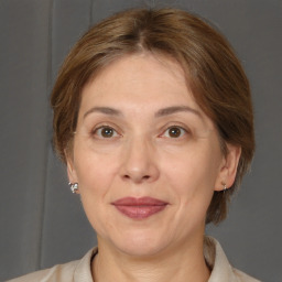 Joyful white adult female with medium  brown hair and brown eyes