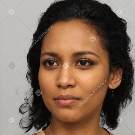 Joyful black young-adult female with medium  black hair and brown eyes