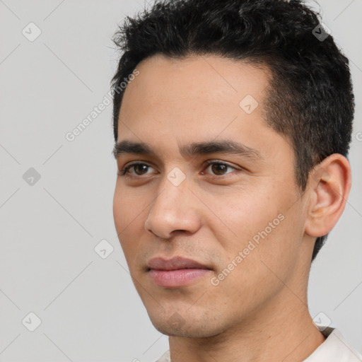 Joyful white young-adult male with short  black hair and brown eyes