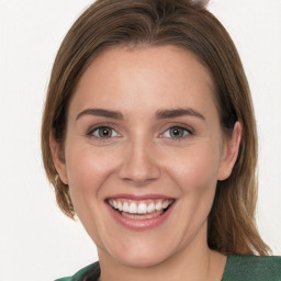 Joyful white young-adult female with medium  brown hair and green eyes