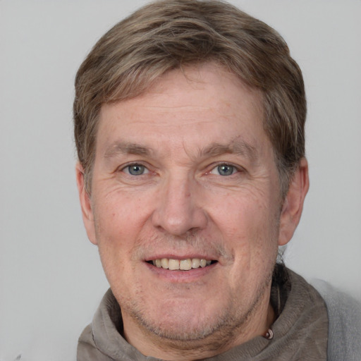 Joyful white adult male with short  brown hair and grey eyes