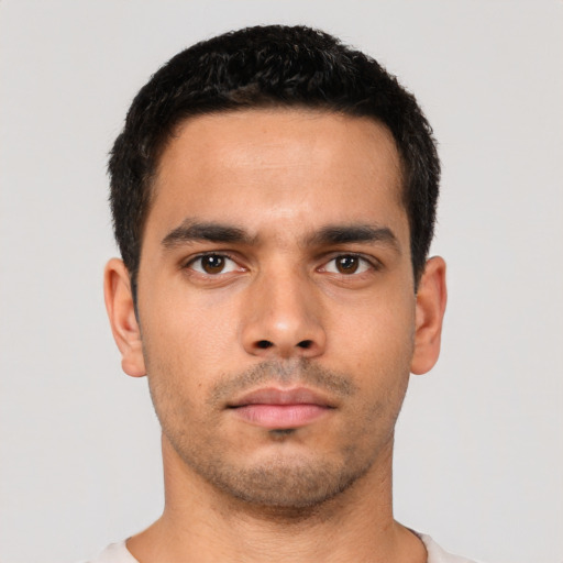 Neutral latino young-adult male with short  black hair and brown eyes