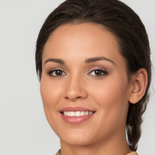 Joyful white young-adult female with long  brown hair and brown eyes