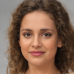 Joyful white young-adult female with long  brown hair and green eyes