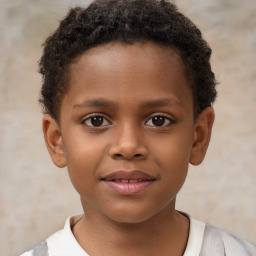 Joyful black child male with short  brown hair and brown eyes