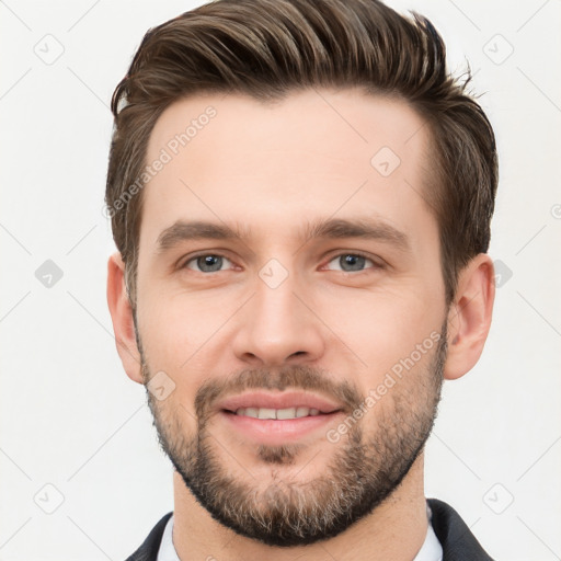 Joyful white young-adult male with short  brown hair and brown eyes