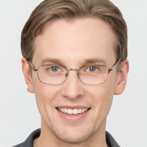 Joyful white adult male with short  brown hair and grey eyes