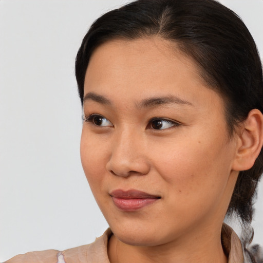 Joyful asian young-adult female with short  brown hair and brown eyes