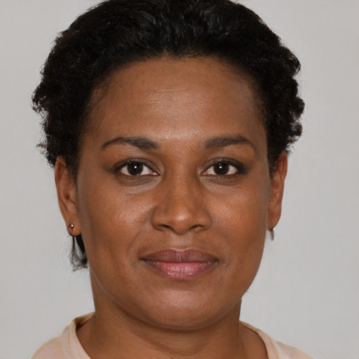Joyful black adult female with short  brown hair and brown eyes