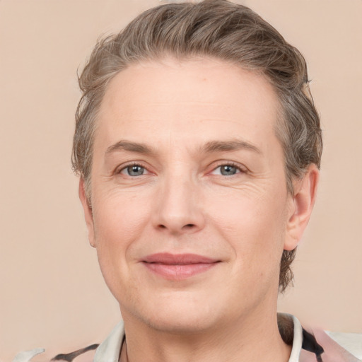 Joyful white adult female with short  brown hair and grey eyes