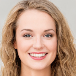 Joyful white young-adult female with long  brown hair and green eyes