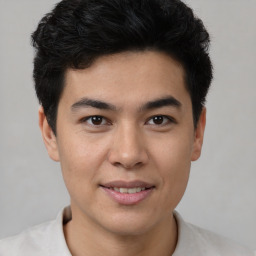 Joyful asian young-adult male with short  black hair and brown eyes