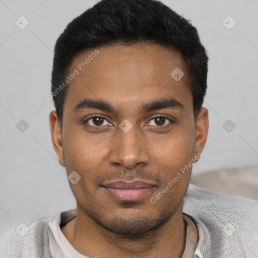 Joyful black young-adult male with short  black hair and brown eyes