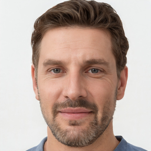 Joyful white adult male with short  brown hair and grey eyes