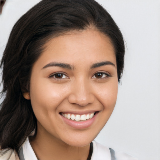 Joyful latino young-adult female with long  brown hair and brown eyes