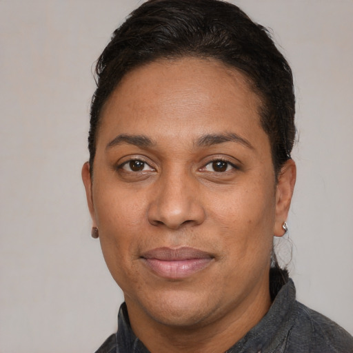 Joyful white adult female with short  black hair and brown eyes