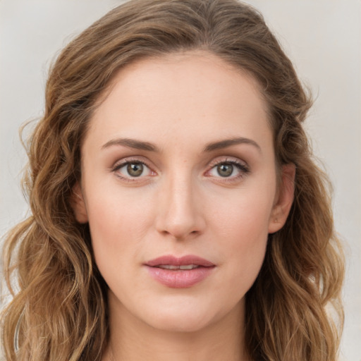 Joyful white young-adult female with long  brown hair and green eyes