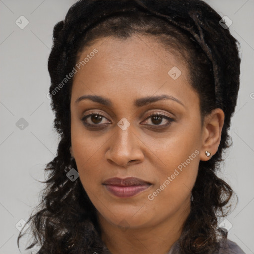 Joyful black young-adult female with long  brown hair and brown eyes