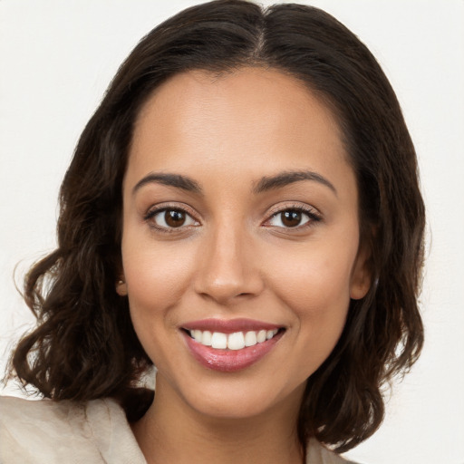 Joyful white young-adult female with long  brown hair and brown eyes