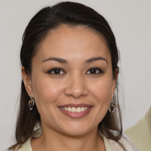 Joyful white young-adult female with medium  brown hair and brown eyes