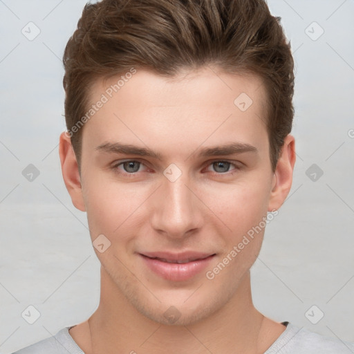 Joyful white young-adult male with short  brown hair and grey eyes