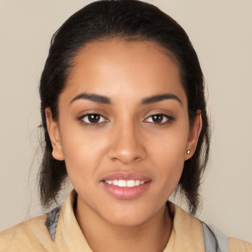 Joyful latino young-adult female with long  black hair and brown eyes