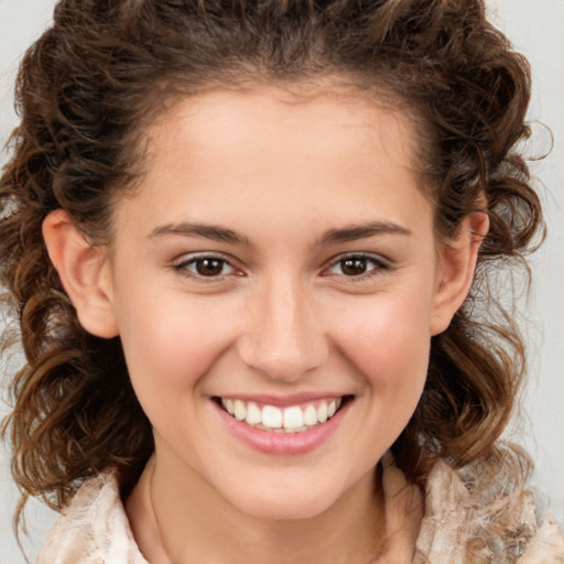 Joyful white child female with medium  brown hair and brown eyes