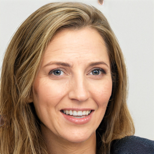 Joyful white adult female with long  brown hair and grey eyes