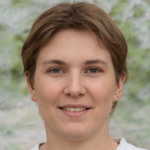 Joyful white young-adult female with short  brown hair and grey eyes