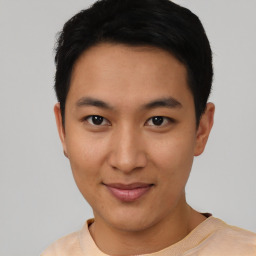 Joyful asian young-adult male with short  black hair and brown eyes