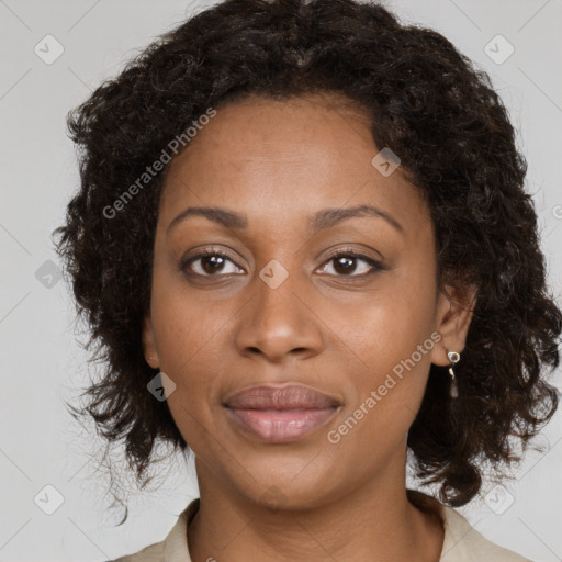 Joyful black adult female with medium  brown hair and brown eyes