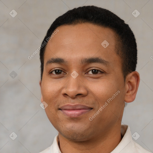 Joyful latino young-adult male with short  black hair and brown eyes