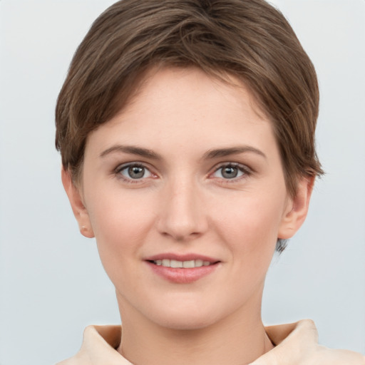 Joyful white young-adult female with short  brown hair and grey eyes