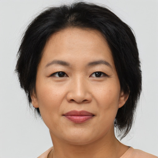 Joyful asian adult female with medium  brown hair and brown eyes