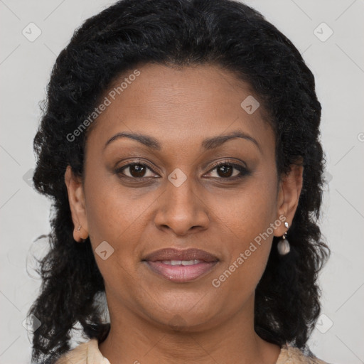 Joyful black adult female with long  brown hair and brown eyes
