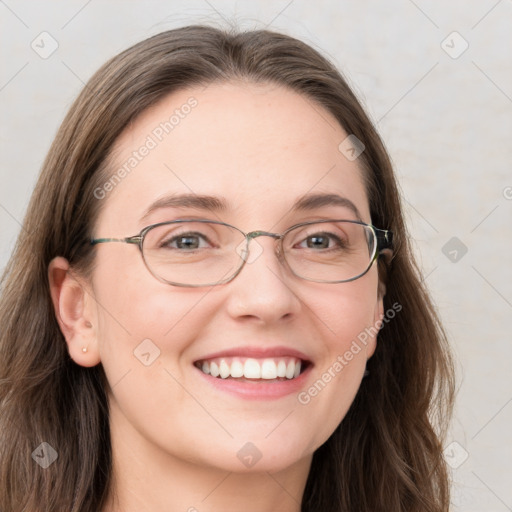 Joyful white young-adult female with long  brown hair and blue eyes