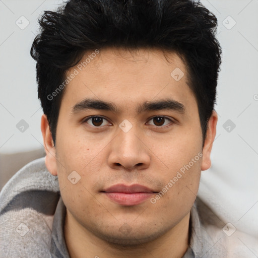 Joyful latino young-adult male with short  brown hair and brown eyes