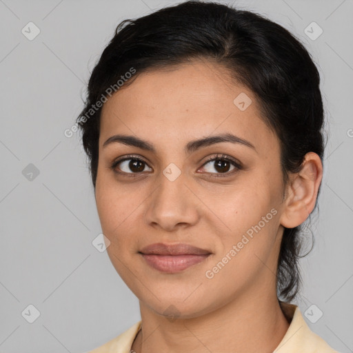 Joyful latino young-adult female with medium  brown hair and brown eyes