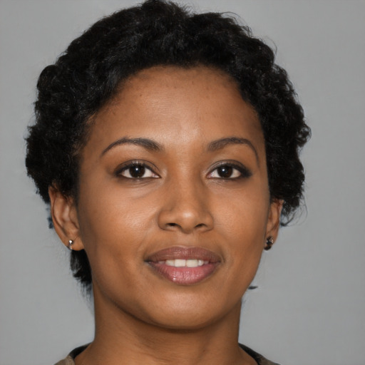 Joyful black young-adult female with short  brown hair and brown eyes