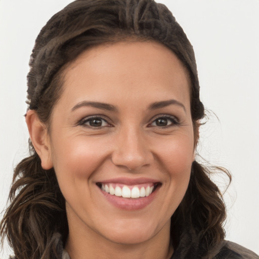 Joyful white young-adult female with long  brown hair and brown eyes