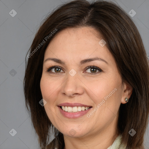 Joyful white adult female with medium  brown hair and brown eyes