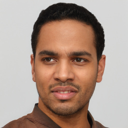 Joyful latino young-adult male with short  black hair and brown eyes