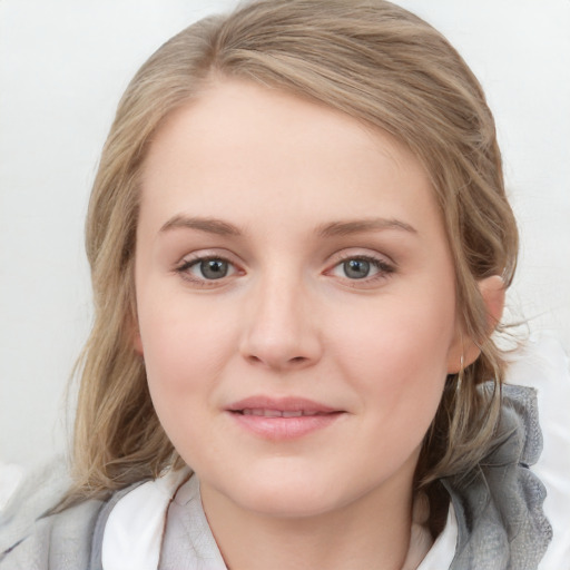 Joyful white young-adult female with medium  brown hair and blue eyes