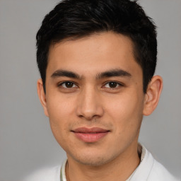 Joyful latino young-adult male with short  brown hair and brown eyes