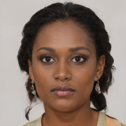 Neutral black young-adult female with medium  brown hair and brown eyes