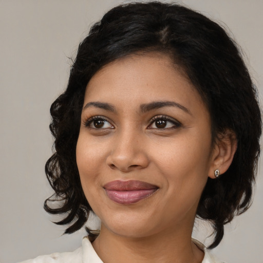 Joyful black young-adult female with medium  black hair and brown eyes