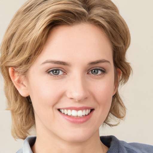 Joyful white young-adult female with medium  brown hair and blue eyes