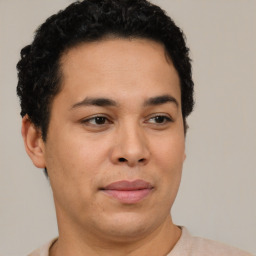 Joyful latino young-adult male with short  brown hair and brown eyes