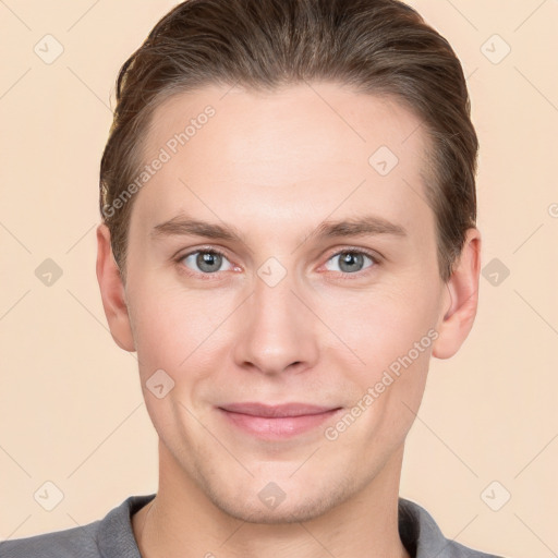 Joyful white young-adult male with short  brown hair and grey eyes